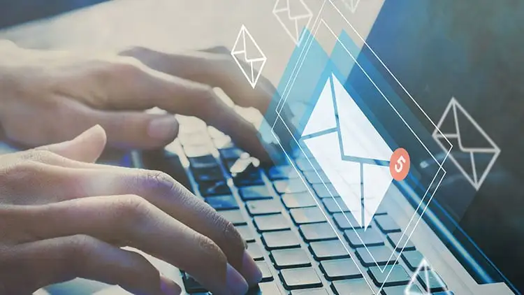 Close-up of hands typing on a laptop keyboard with digital envelope icons and a red notification badge floating above.